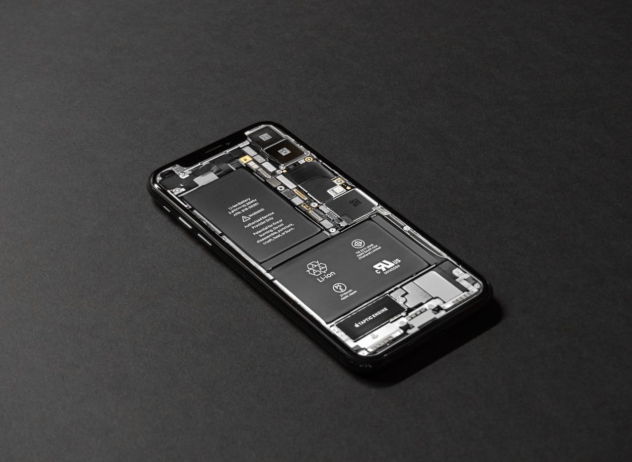 team-04 High-resolution image of a smartphone showcasing its internal components on a dark surface.